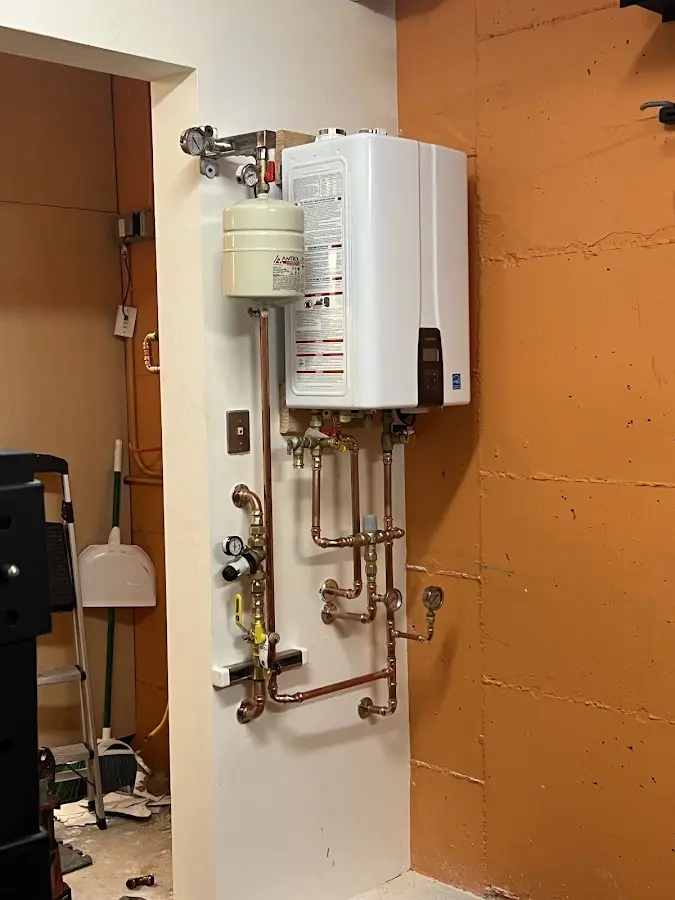 Plumbing technician inspecting water heater connections in Vidalia